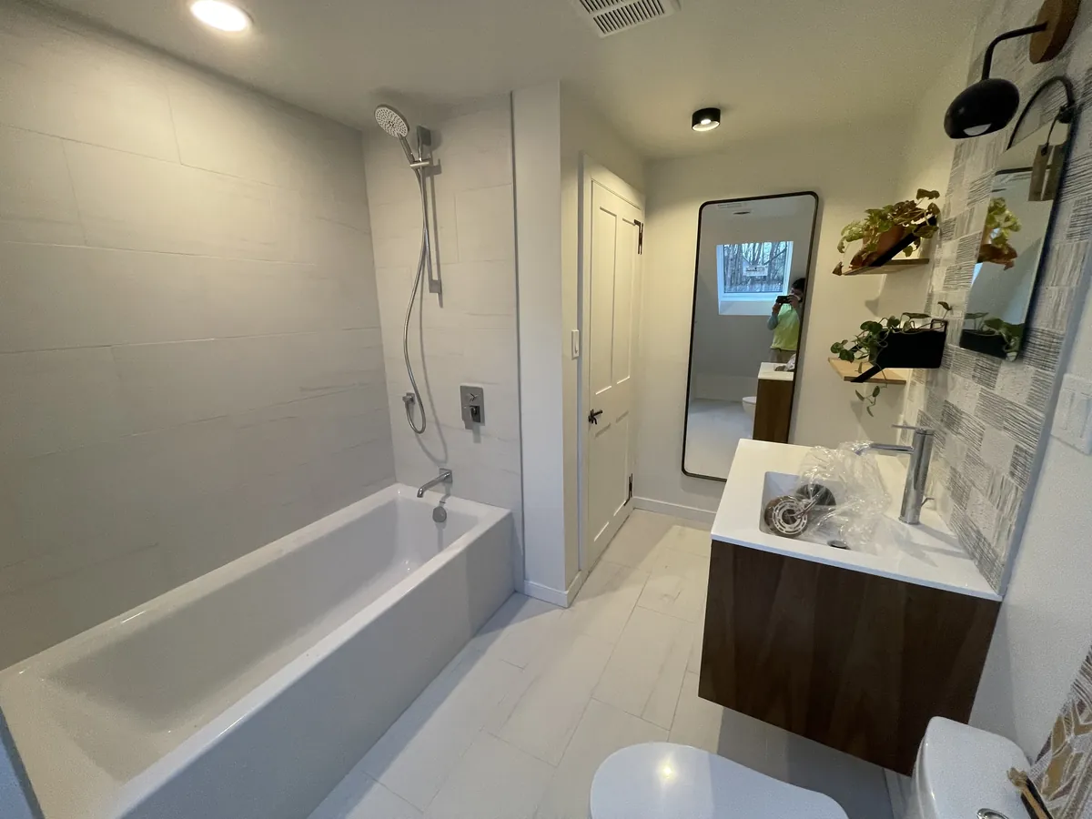 Soaking tub and floating walnut vanity