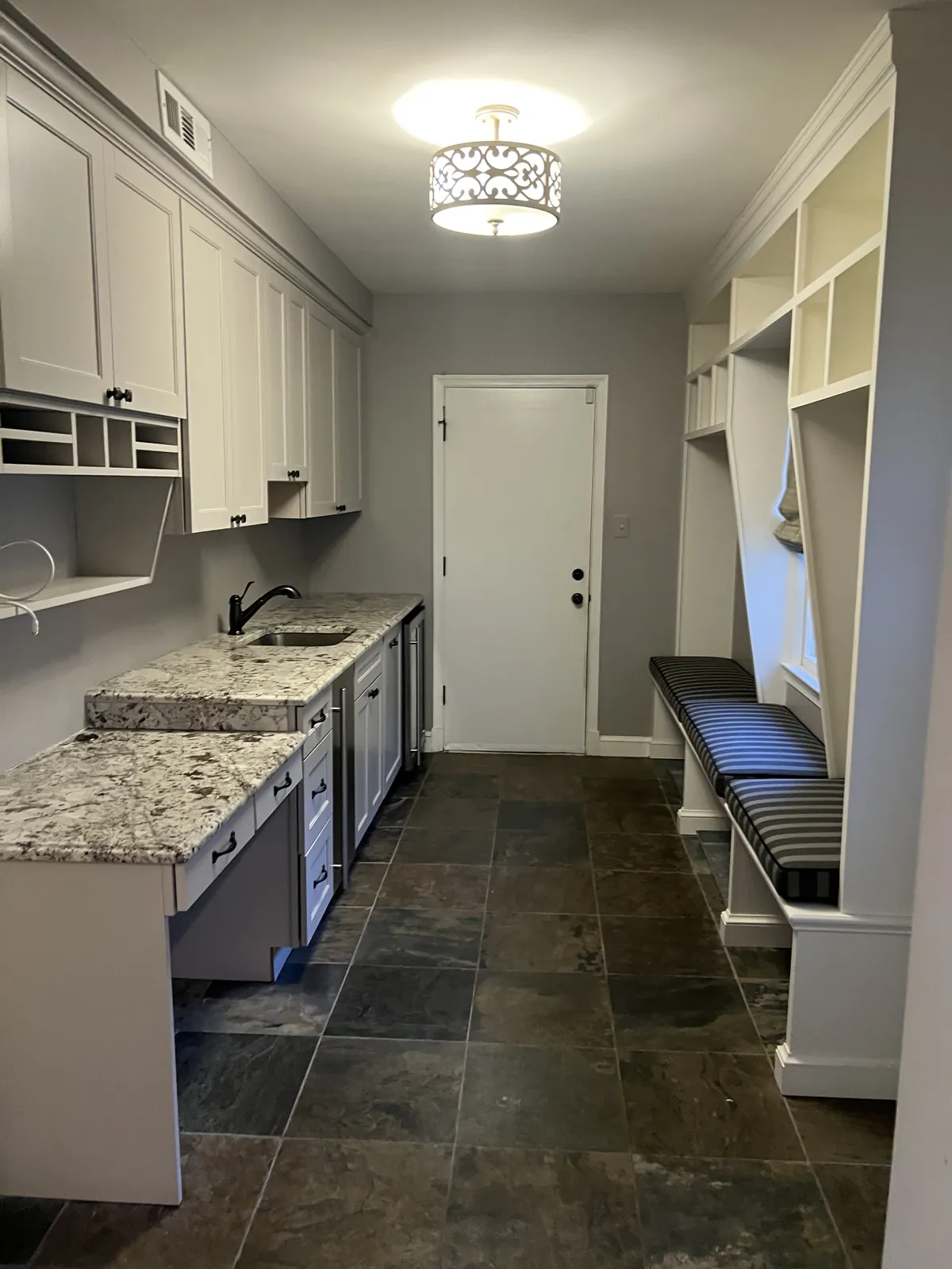 Mudroom with built-in bench and cabinetry