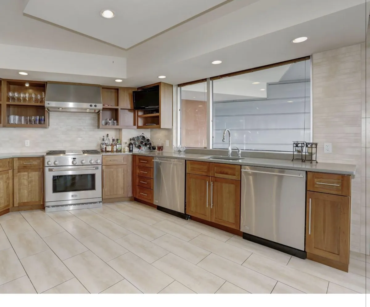 Wood cabinetry with open shelving and a professional range